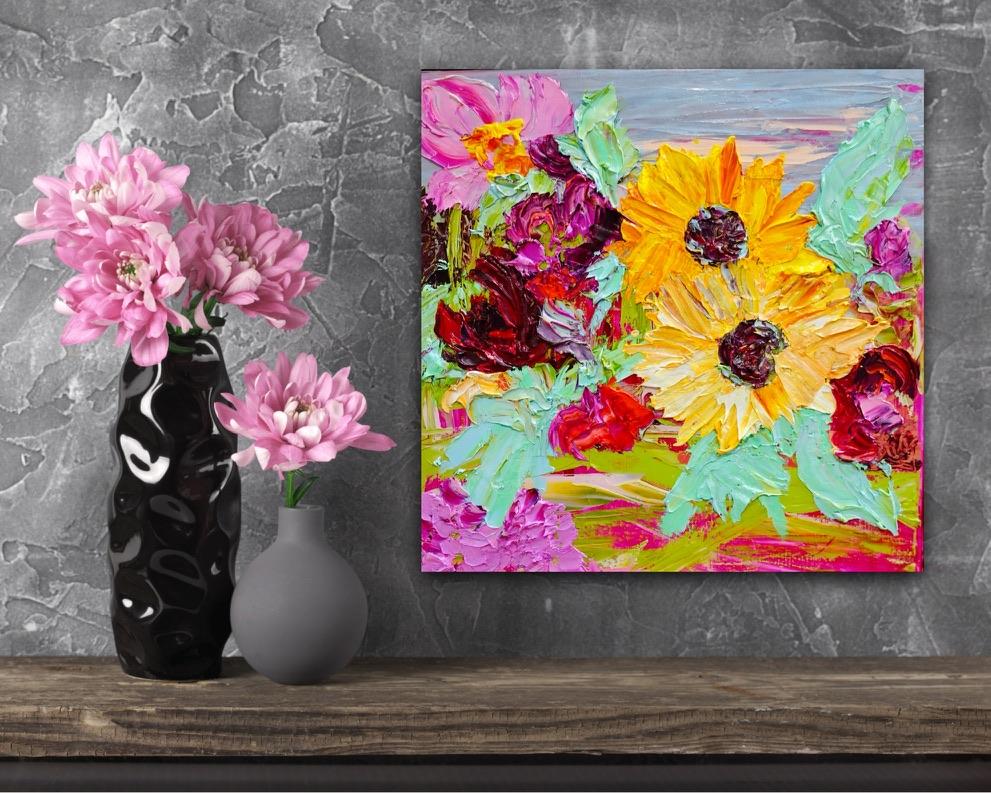 Sunshine is an original painting of yellow, hot pink and red flowers with pale green/blue leaves, acrylic on canvas, 43cm x 43cm. Shown in situ against a marbled grey wall.