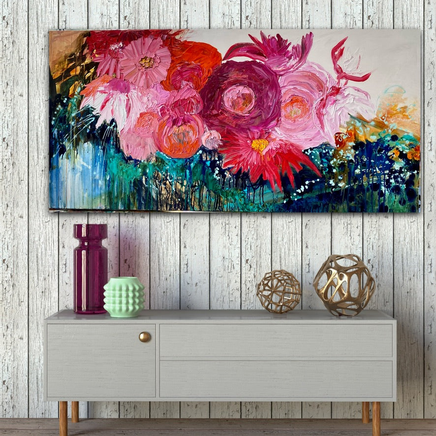 Midnight in the Garden is a large, impressionist style original painting of a mass of hot pink, pale pink and orange blooms on a turquoise, aqua and white background, oil on canvas, light Tasmanian Oak box frame152cm x 76cm. In situ on a white panelled wall.