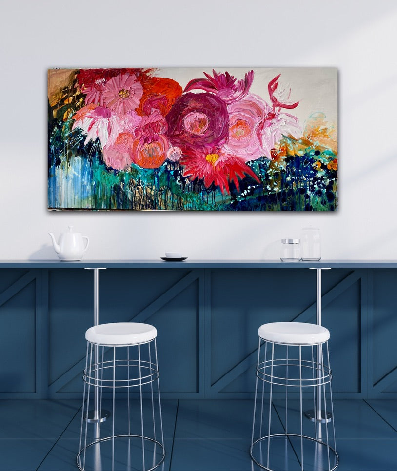 Midnight in the Garden is a large, impressionist style original painting of a mass of hot pink, pale pink and orange blooms on a turquoise, aqua and white background, oil on canvas, light Tasmanian Oak box frame152cm x 76cm. In situ on a white wall above a blue kitchen bench.