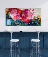 Load image into Gallery viewer, Midnight in the Garden is a large, impressionist style original painting of a mass of hot pink, pale pink and orange blooms on a turquoise, aqua and white background, oil on canvas, light Tasmanian Oak box frame152cm x 76cm. In situ on a white wall above a blue kitchen bench.
