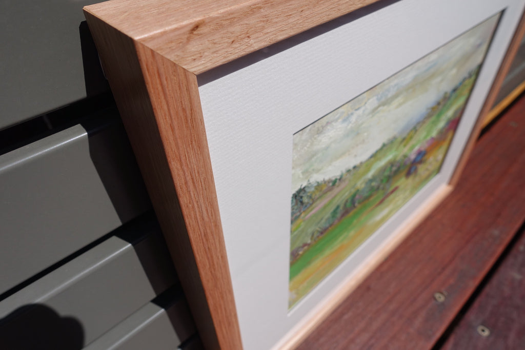 Abstract painting of a green countryside. Close-up of frame.