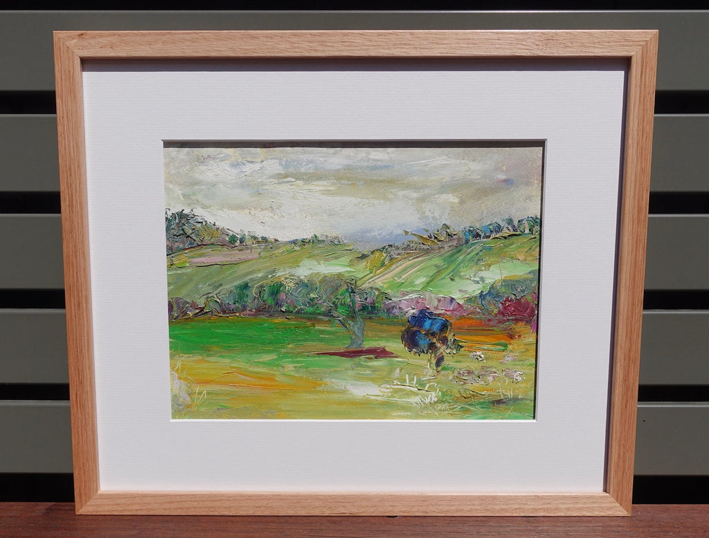 Abstract painting of a green countryside. Framed view.