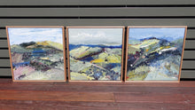Load image into Gallery viewer, Abstract oil painting of a country landscape with steep hills and lots of colour, yellow, pink, green and blue against a pale blue sky with white clouds. Alongside matching paintings Our Land and Hill End.
