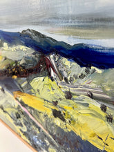 Load image into Gallery viewer, Abstract oil painting of a country landscape with steep hills and lots of colour, yellow, pink, green and blue against a pale blue sky with white clouds. Detail view.
