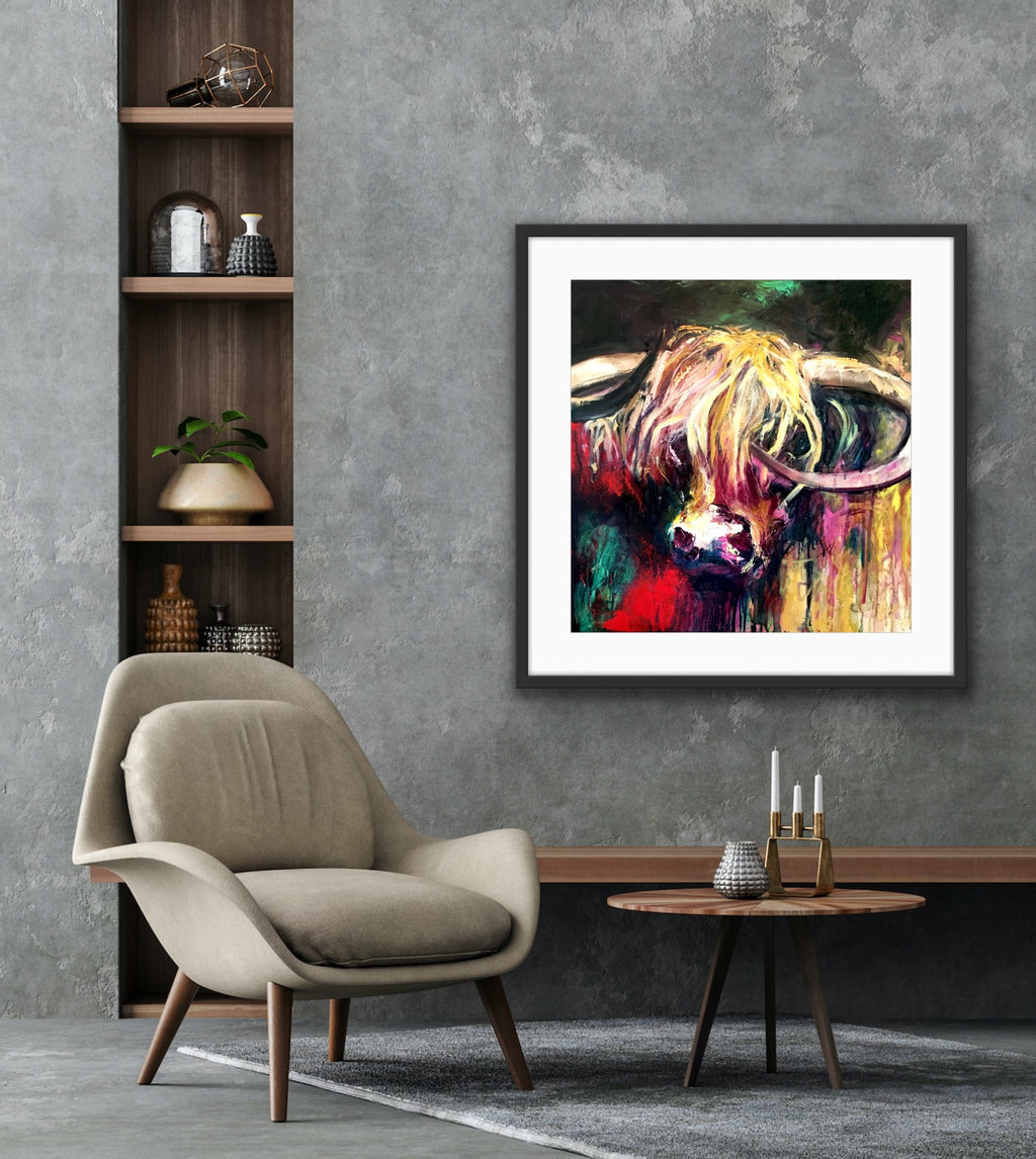 A lovely print of Curly the bull with his head against a background of emerald, red, gold, pink and black in a black frame.