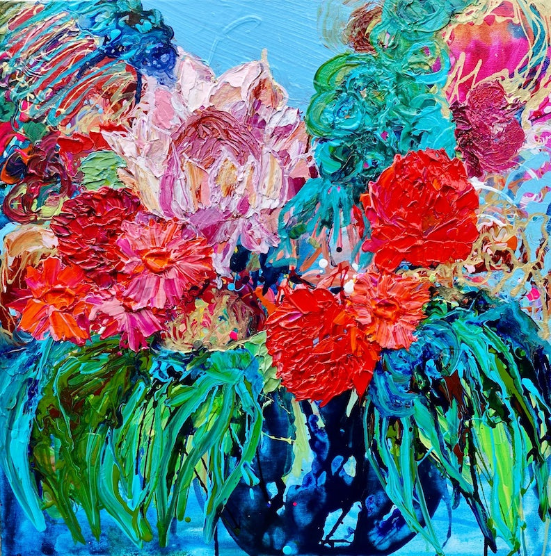 Proteas, pinks, magenta, reds, waratah, australian natives in a deep blue vase against an aqua background.