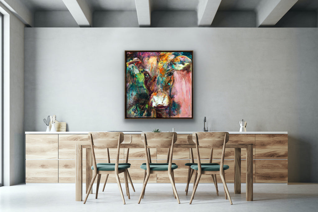 A gorgeous print of Dairy Queen the cow. Set against a muted, multi coloured background in a timber frame.