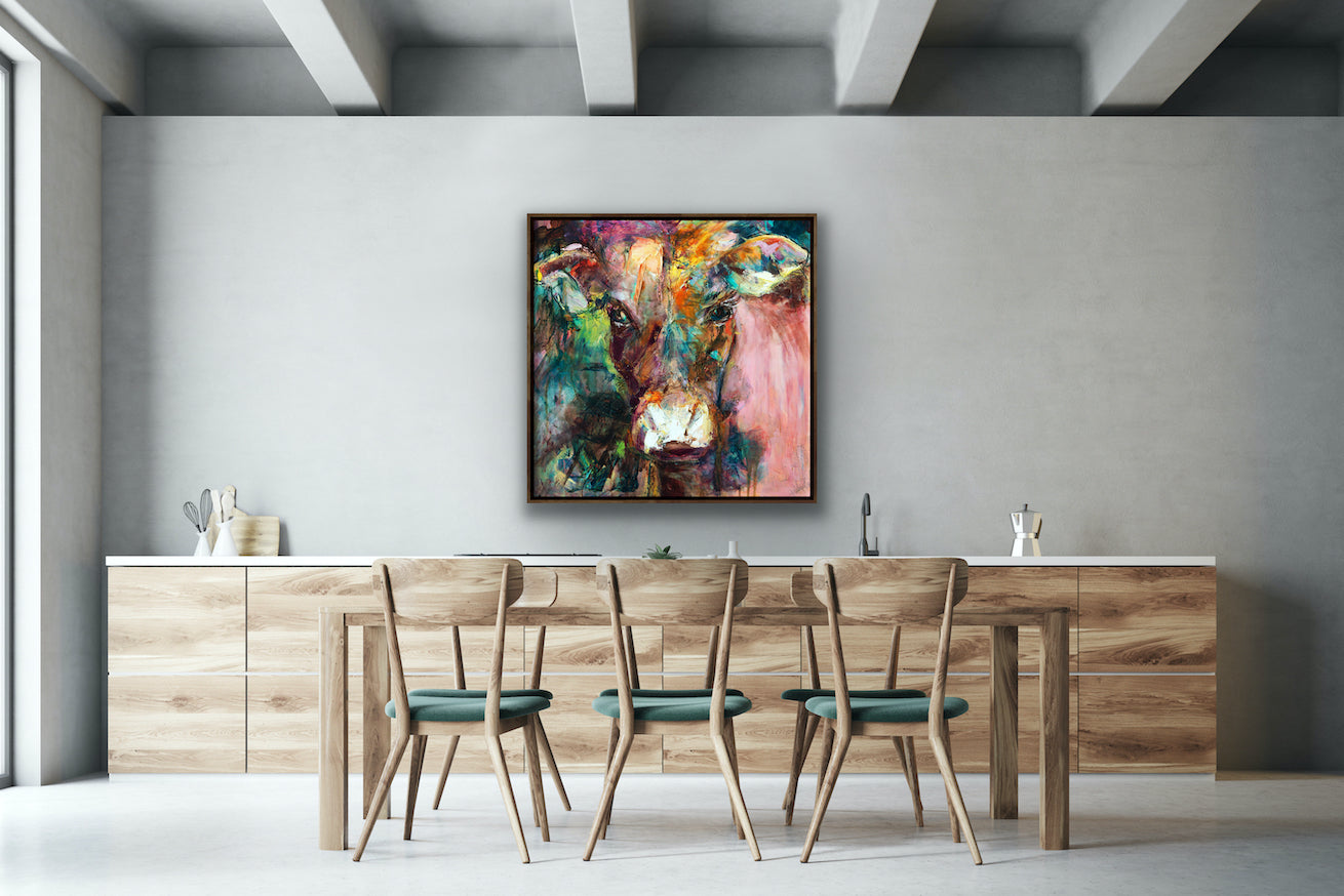 A gorgeous print of Dairy Queen the cow. Set against a muted, multi coloured background in a timber frame.