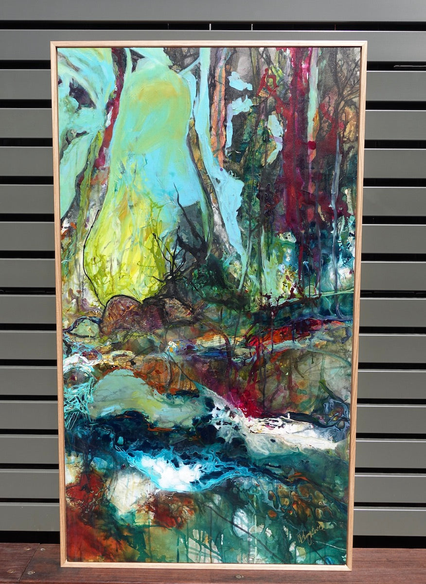 Abstract multicoloured oil painting of a creek, surrounded by trees. Framed view.