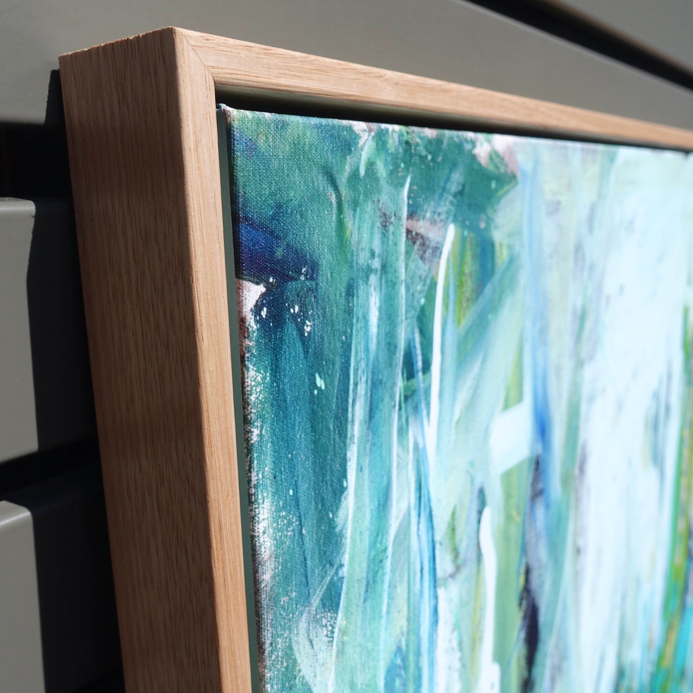 Abstract painting of a forest in lovely shades of turquoise and aqua. Detail view.