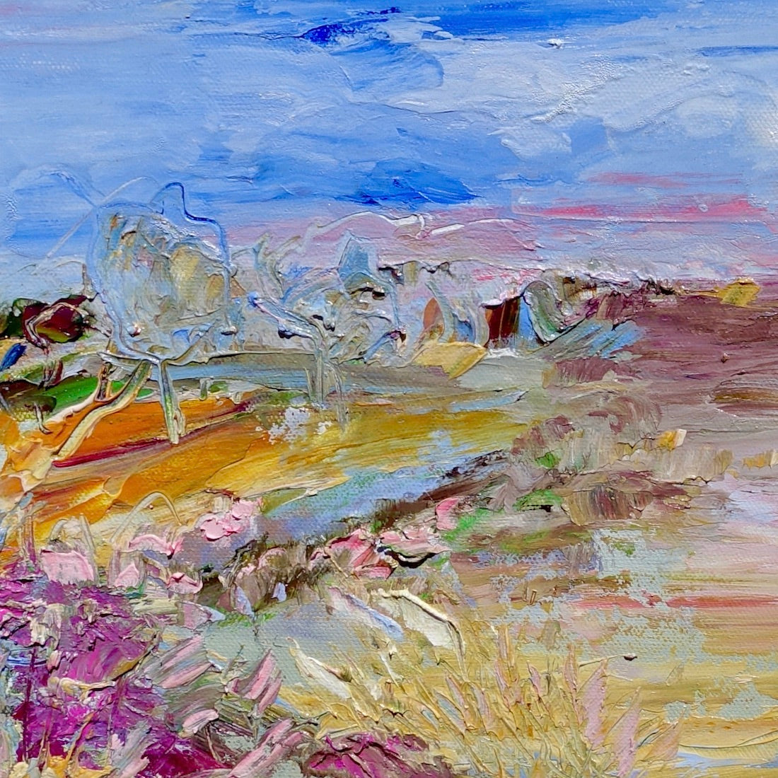 Abstract painting of a field in shades of pink, orange and yellow against a blue sky. Square view.