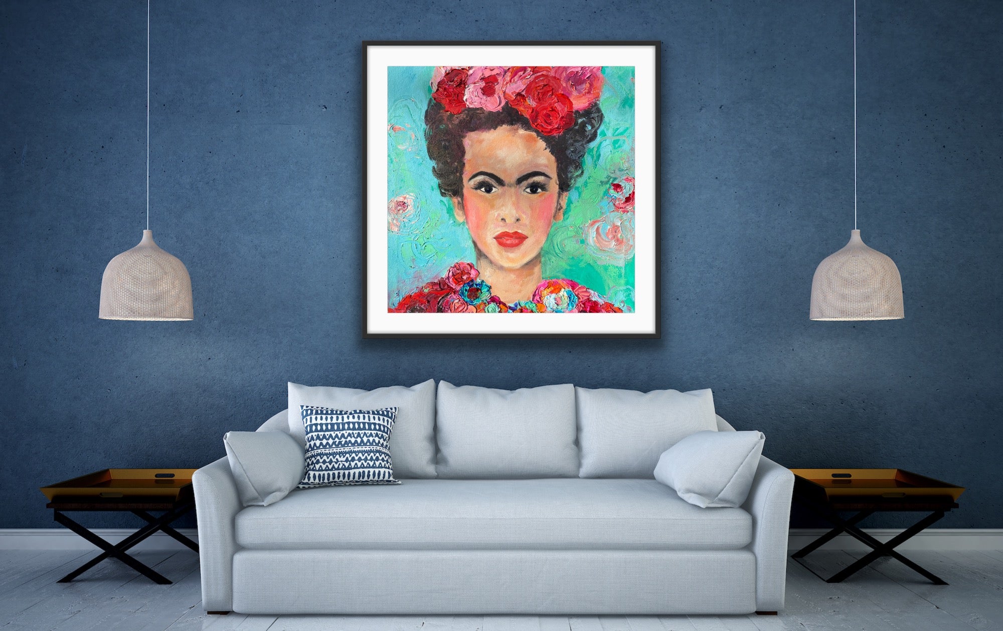 A beautiful and colourful print of Frida Kahlo with red and pink flowers in Frida's hair against a turquoise and aqua background , in a black frame.