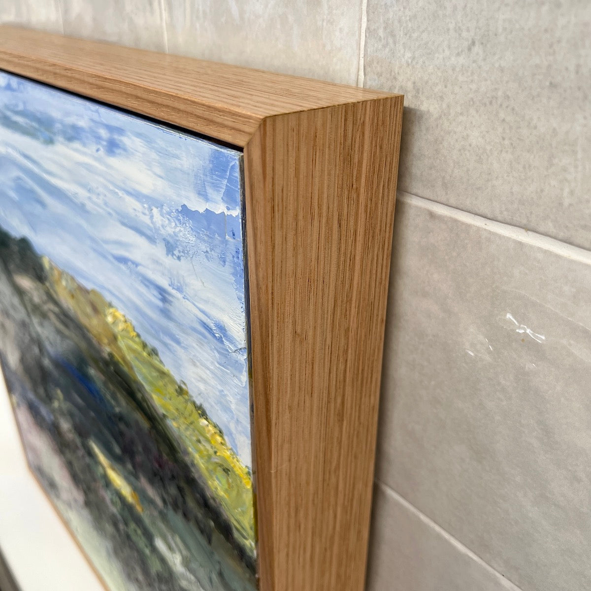 Abstract landscape with the countryside painted in yellow, pink, green and blue. Side View.