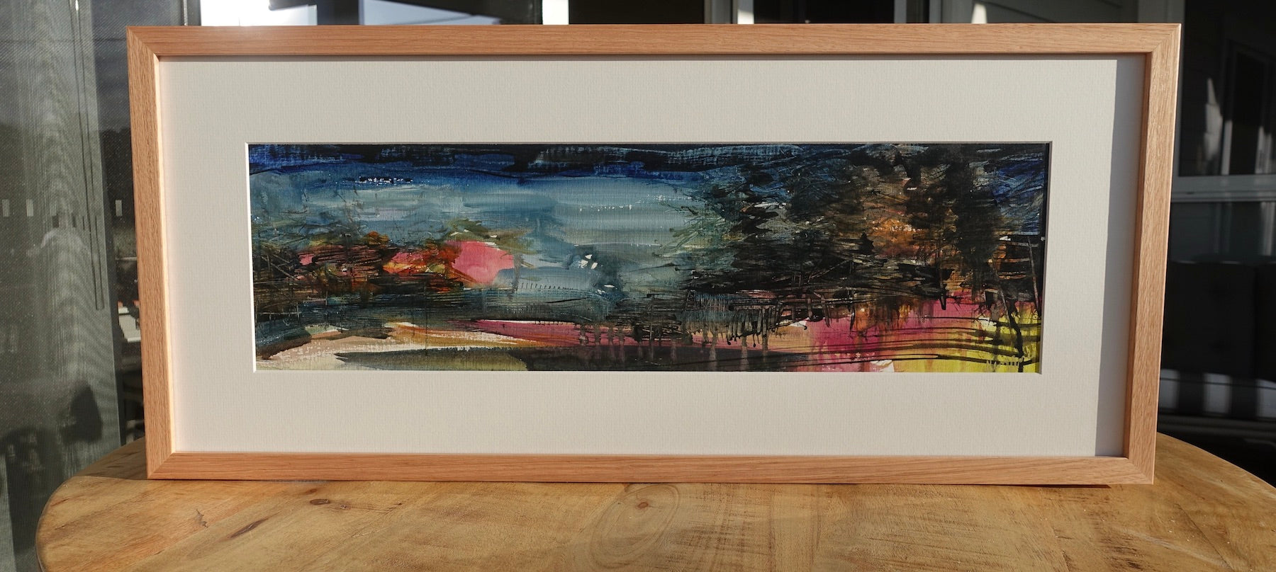 Kiama pine trees and a view to the ocean painted in an abstract style. Framed view.