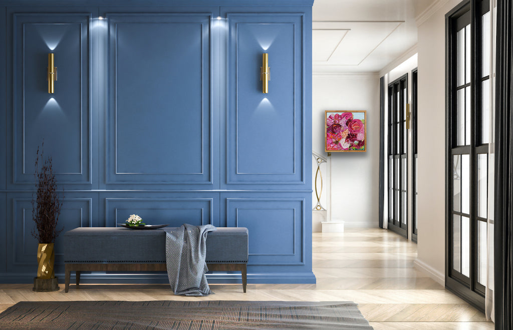 A painting of a gorgeous bunch of florals in all shades of pink, entwined with gold thread on a pale blue background in situ.