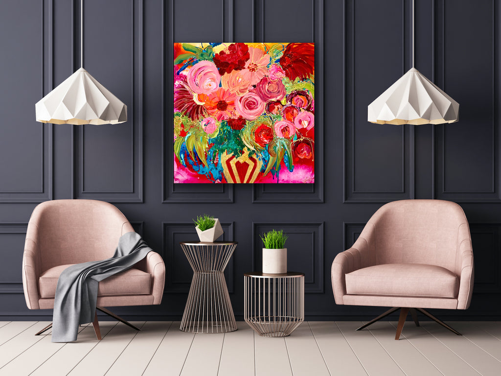 Petal Power is an original painting of a stunning mass of flowers in a gold and red vase against a hot pink background. 94cm x 94cm, acrylic on linen, framed in Tassie Oak box frame. Shown in situ on a charcoal wall above 2 pink arm chairs.