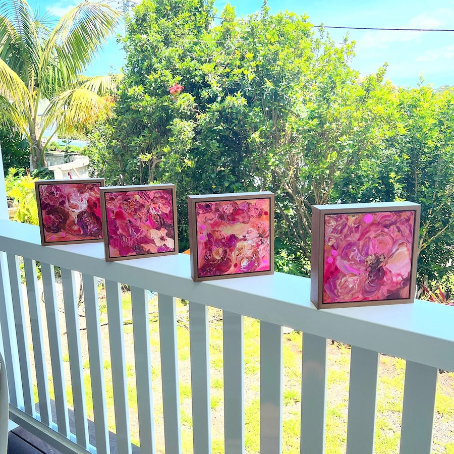Pink blooms in all the shades of pink. Shown with 3 paintings from the same series, sitting on a veranda railing.