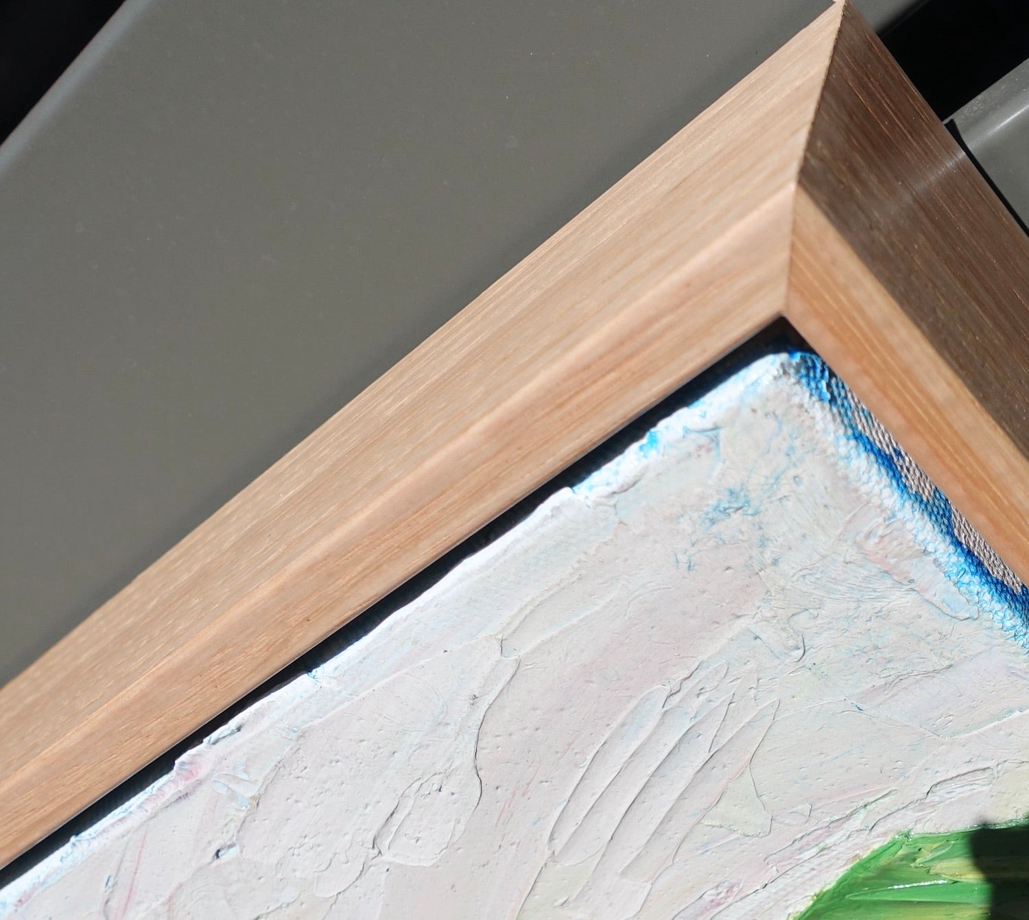 Abstract landscape of rolling green and yellow hills and a winding pink road. View of frame.