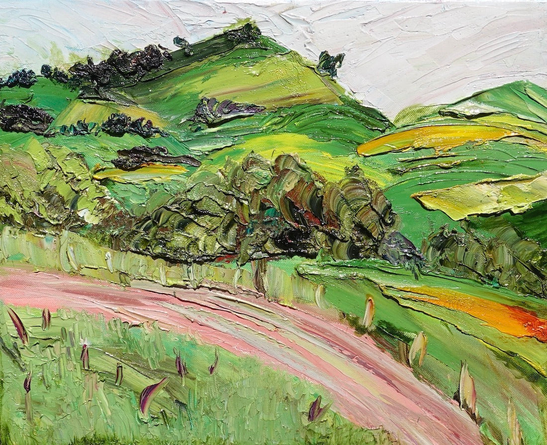 Abstract landscape of rolling green and yellow hills and a winding pink road.