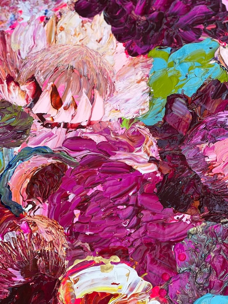 Pink flowers in varying shades in a red vase. Detail view.