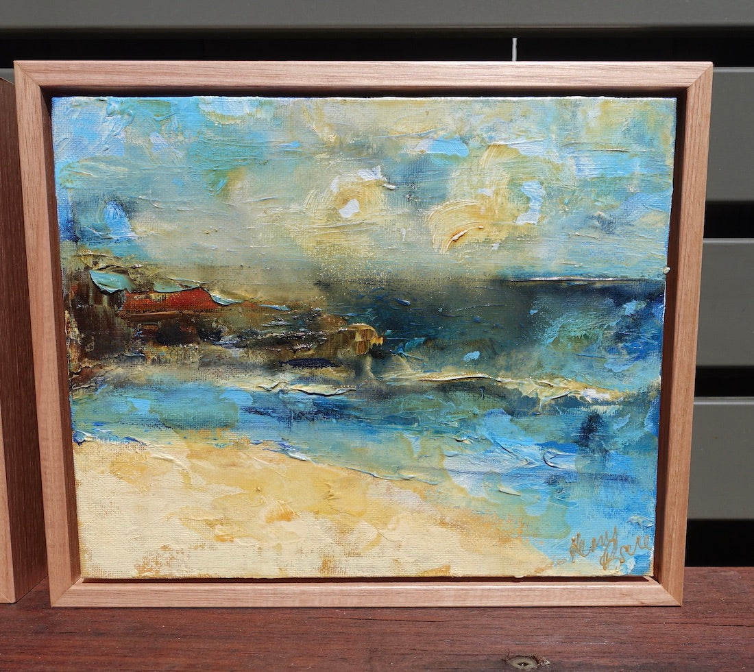 Abstract coastal scene in shades of yellow and blue. Framed view.