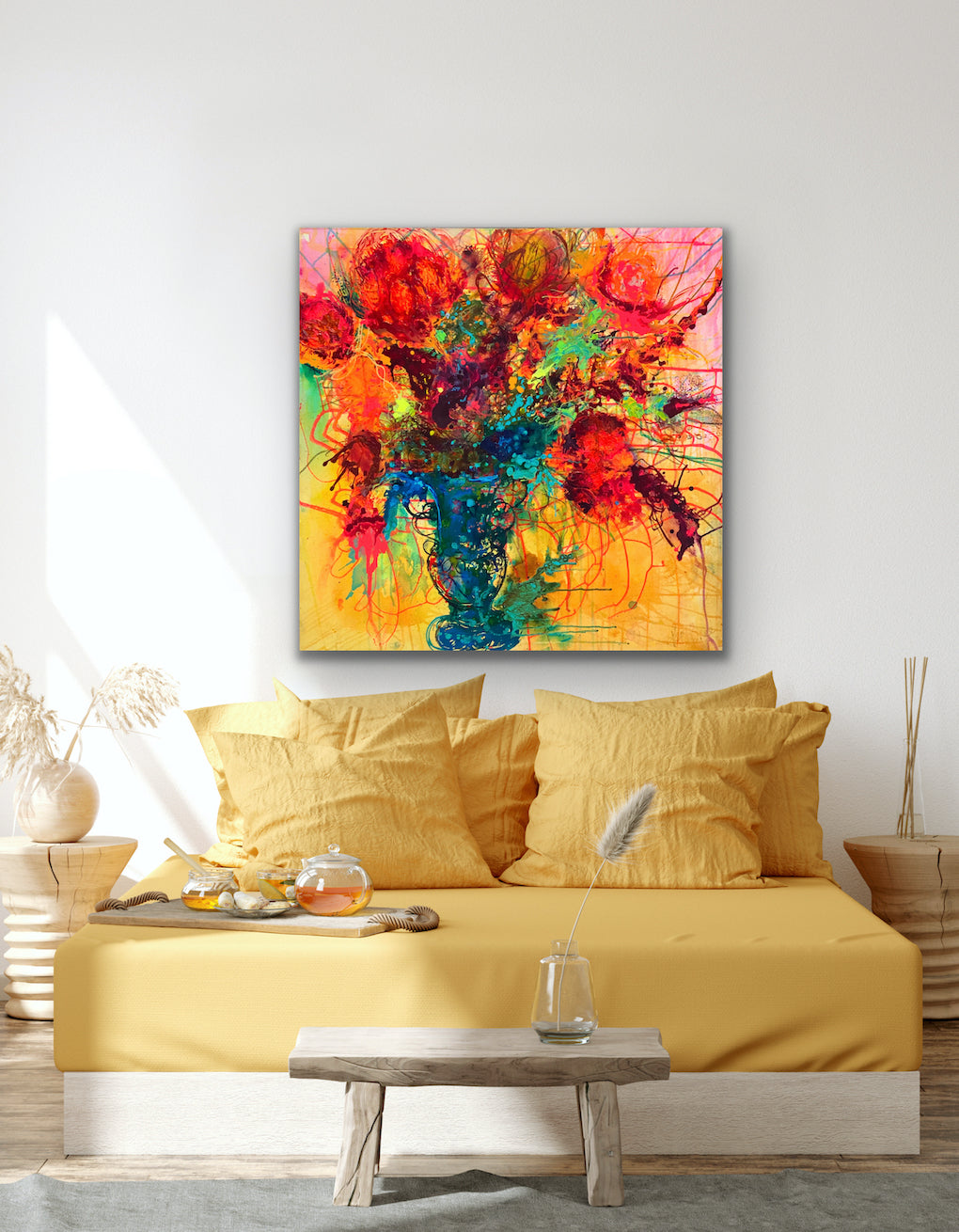 Original painting of a blue vase filled with coral blooms on a yellow background. Acrylic on canvas, framed in an oak box frame. Shown in situ in a living room  with a yellow sofa.