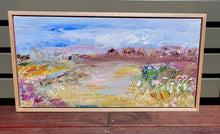 Load image into Gallery viewer, Abstract painting of a field in shades of pink, orange and yellow against a blue sky. Framed view.
