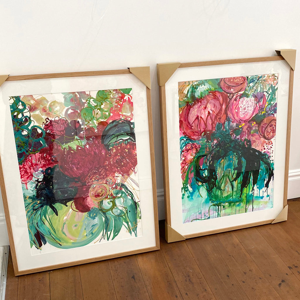 Framed Original artwork on 500gsm paper by Kerry Bruce featuring a Vase of flowers with a mass of vibrant colourful blooms and shades of hot pink, pale pink, turquoise, aqua and green. Show here with Native Wonder original artwork on paper.